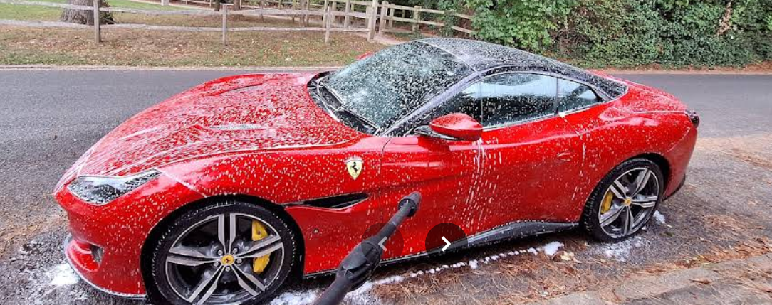 The same red Ferrari during its snow foam wash